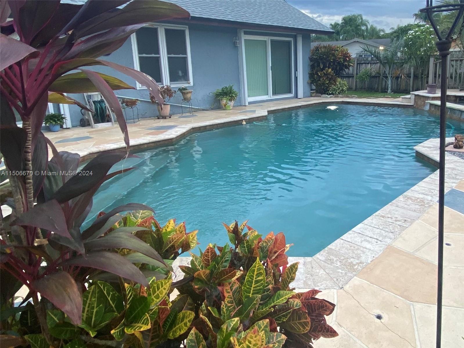 13341 Southwest 101st Street Miami, FL 33186 - Photo 3 of 43 a view of a swimming pool with a patio