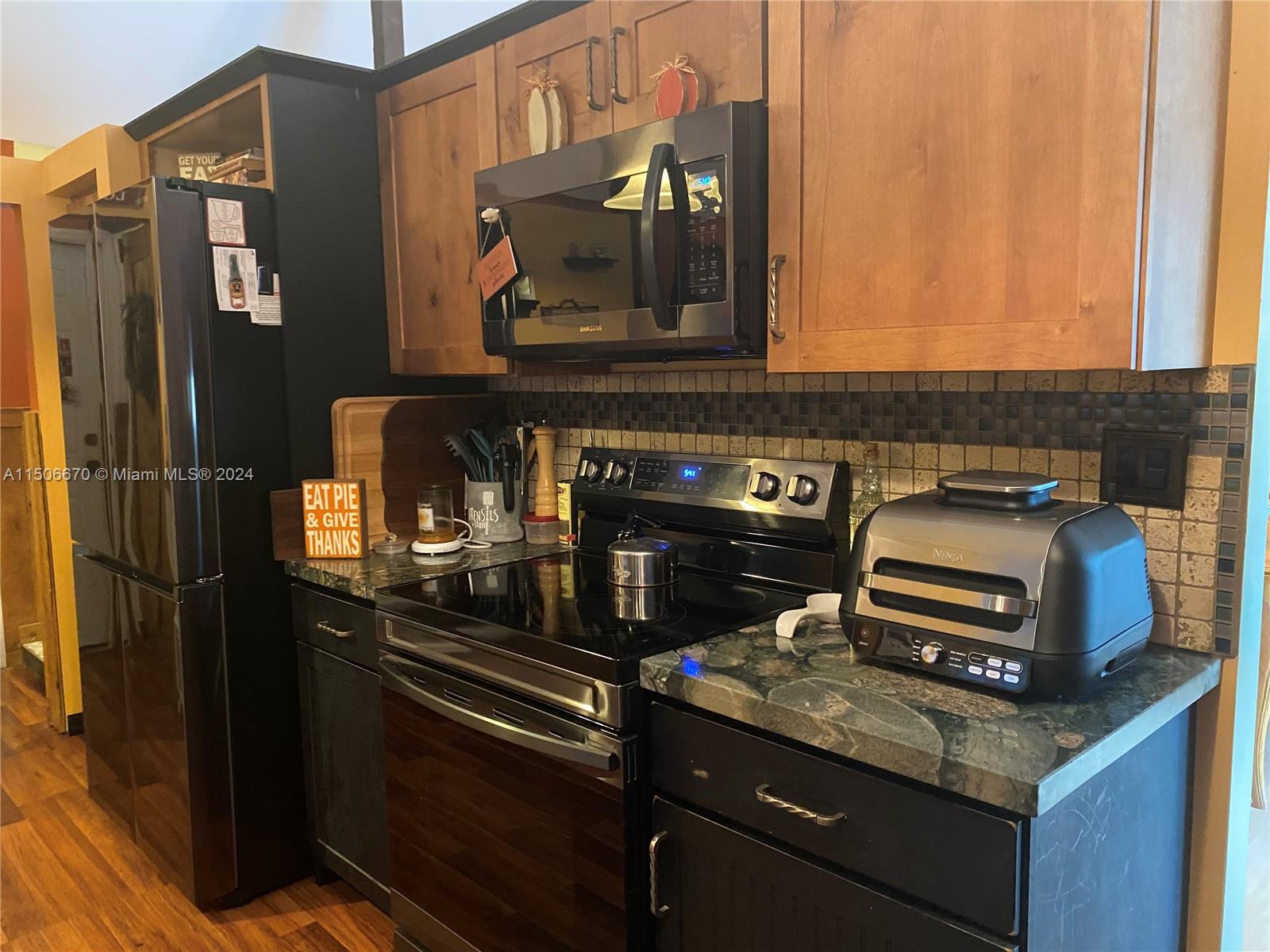 13341 Southwest 101st Street Miami, FL 33186 - Photo 6 of 43 a kitchen with a stove and a microwave