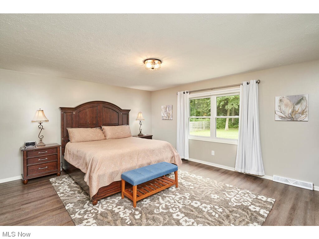 5535 River Styx Road Medina, OH 44256 - Photo 15 of 27 Luxury vinyl floored bedroom with a textured ceiling