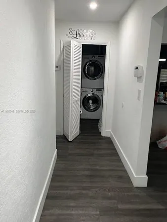 a view of a hallway with washer and dryer
