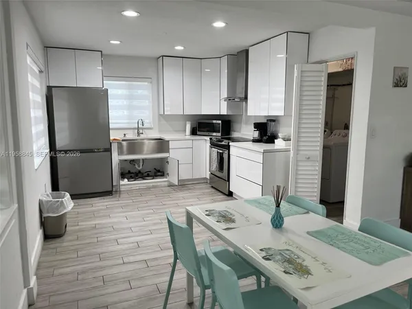 a kitchen with a table and refrigerator