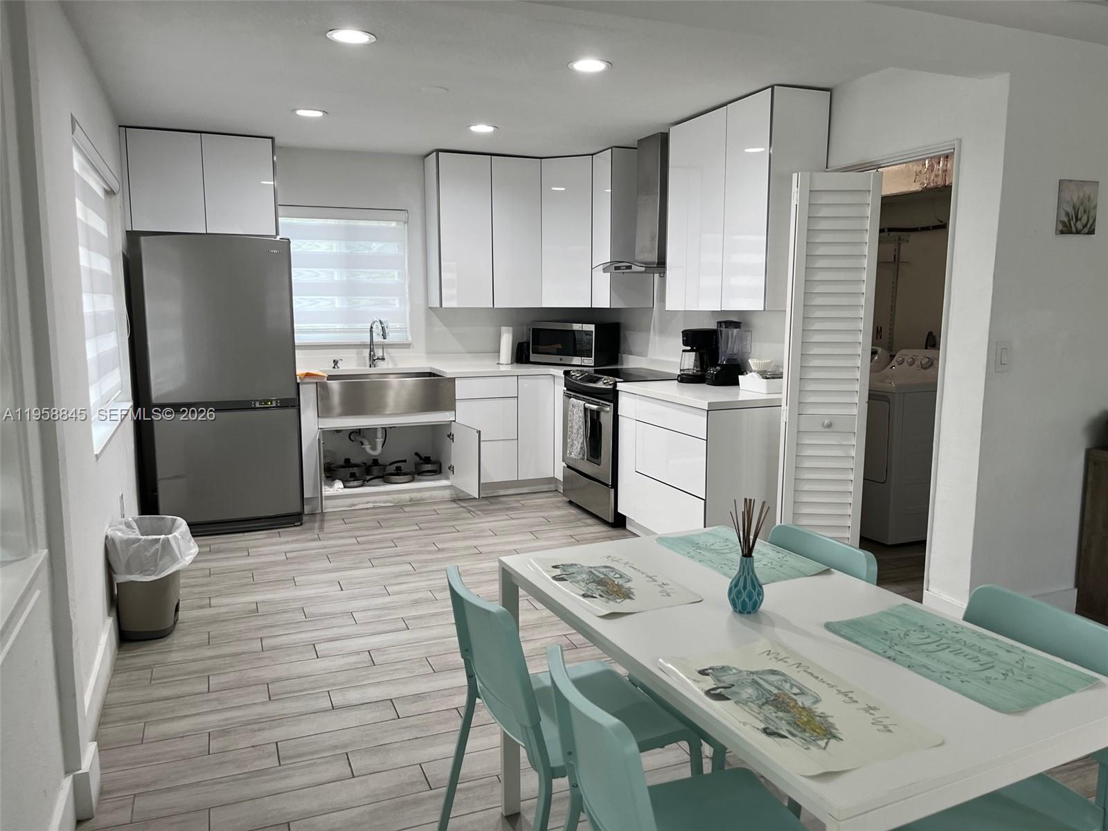 3008 Northwest 13th Street Miami, FL 33125 - Photo 15 of 32 a kitchen with a table and refrigerator