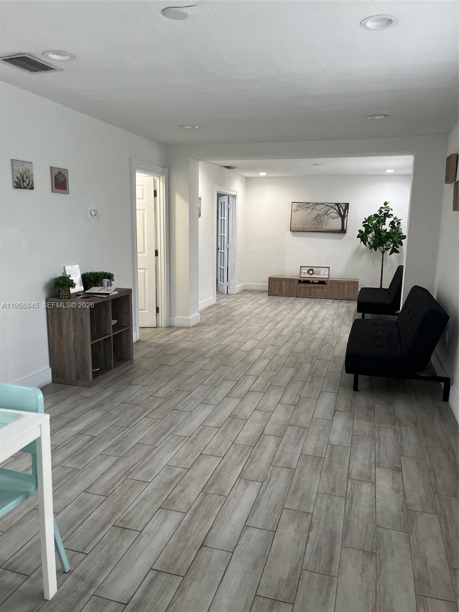 3008 Northwest 13th Street Miami, FL 33125 - Photo 16 of 32 a living room with furniture and wooden floor