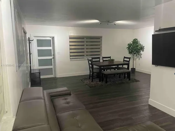 a dining room with furniture and wooden floor
