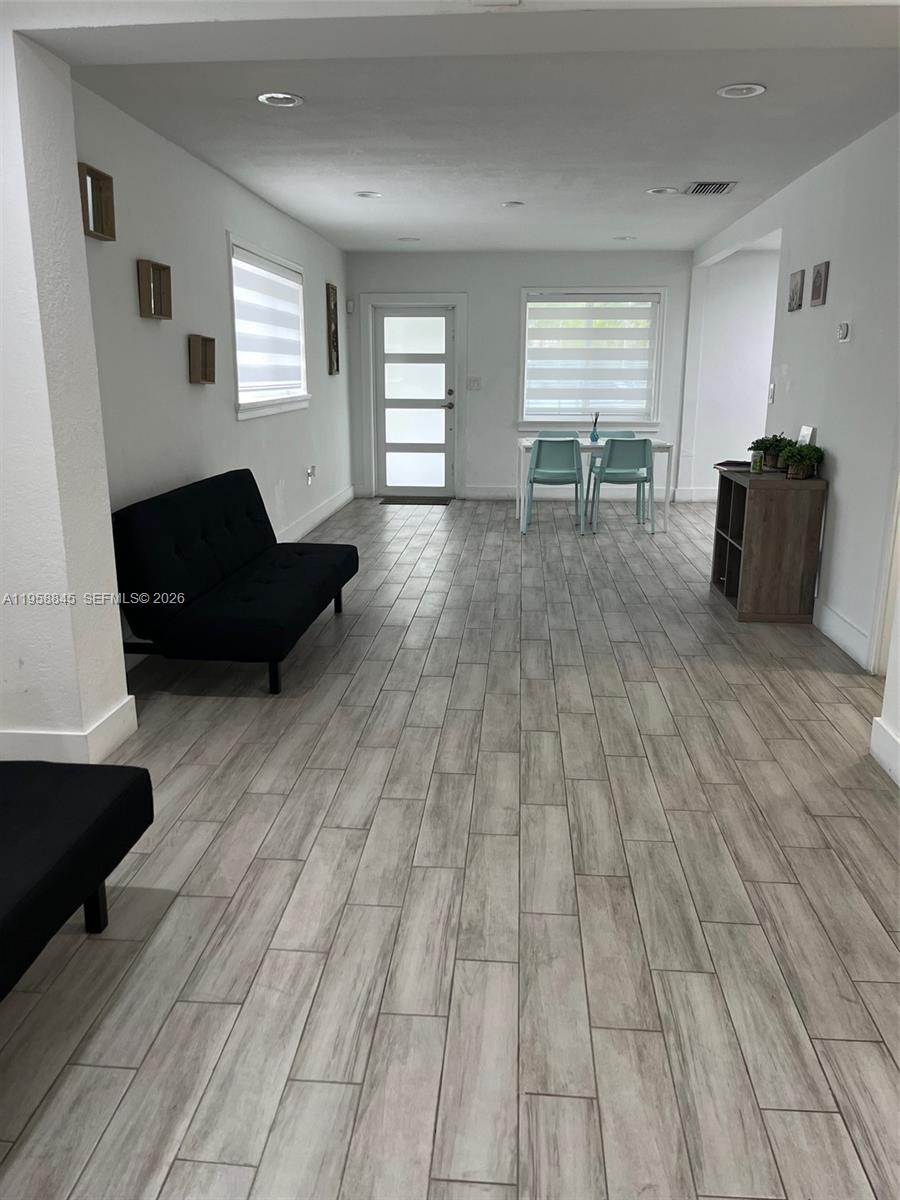 3008 Northwest 13th Street Miami, FL 33125 - Photo 22 of 32 a living room with furniture and a wooden floor
