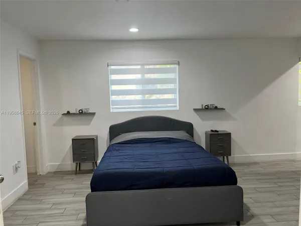 a bedroom with a bed and a flat tv screen