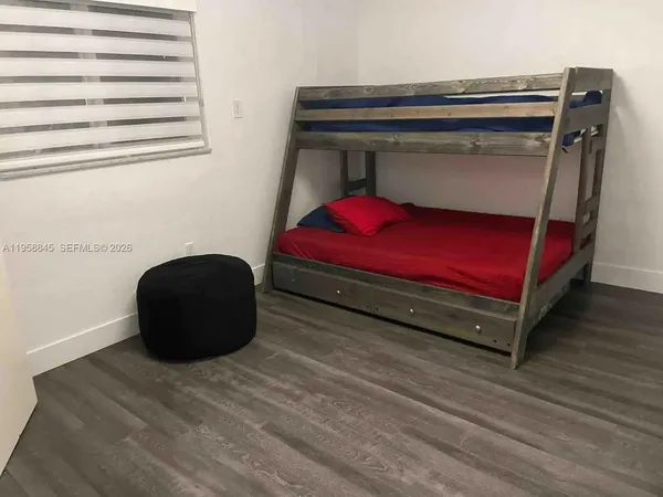 a bedroom with a bed and a chair