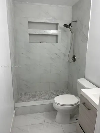 a bathroom with a toilet and a shower