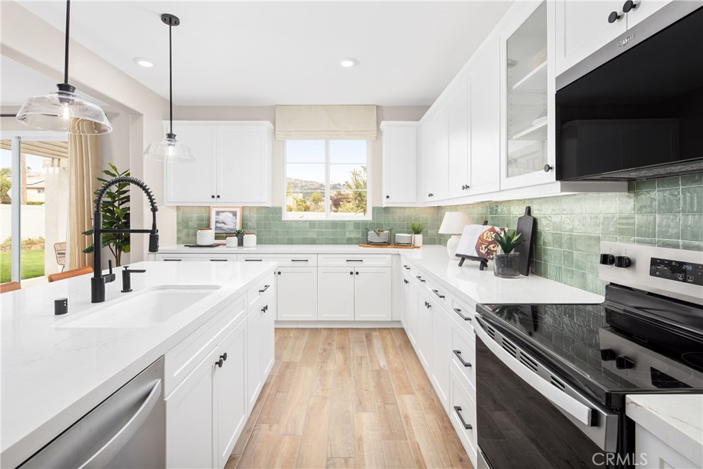 2025 Simpatico Place Escondido, CA 92026 - Photo 2 of 15 a kitchen with a sink stove and microwave