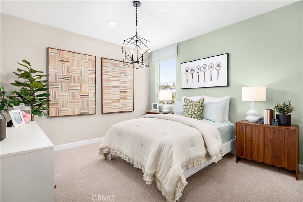 2025 Simpatico Place Escondido, CA 92026 - Photo 8 of 15 a spacious bedroom with a bed and a chandelier