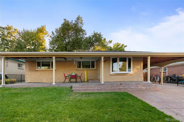 a backyard of a house with table and chairs