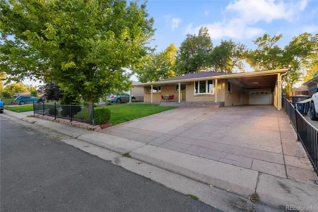 a view of a white house with a yard