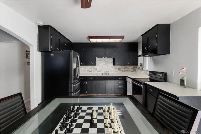 a kitchen with stainless steel appliances granite countertop a refrigerator stove and sink