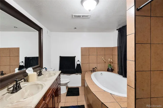 a bathroom with a sink double vanity and tub