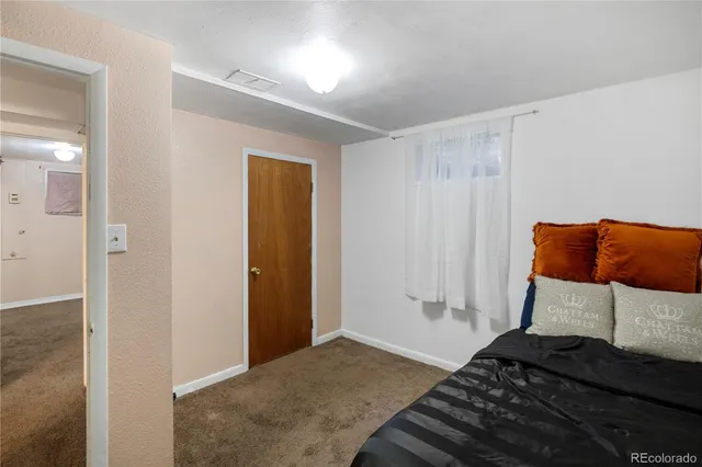 a bedroom with a bed and a chair