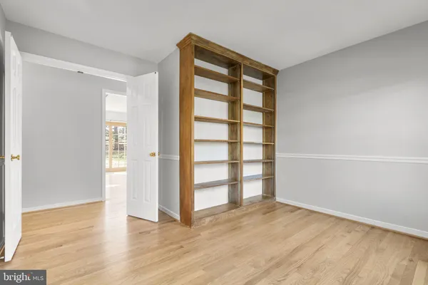 an empty room with wooden floor and closet