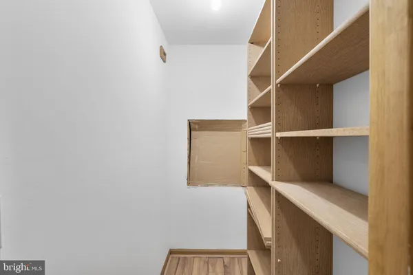 a view of walk in closet with empty racks