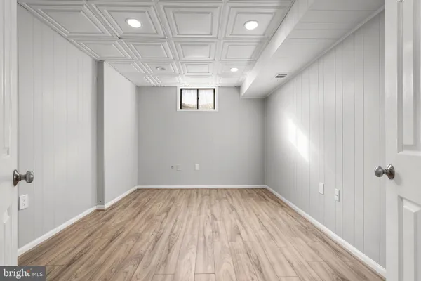 a view of a room with wooden floors and chandelier
