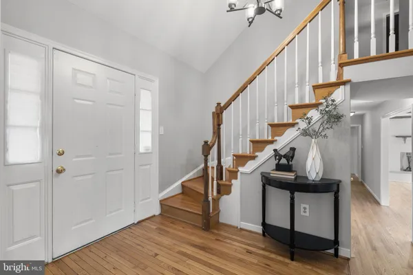 a view of entryway with wooden floor and stairs
