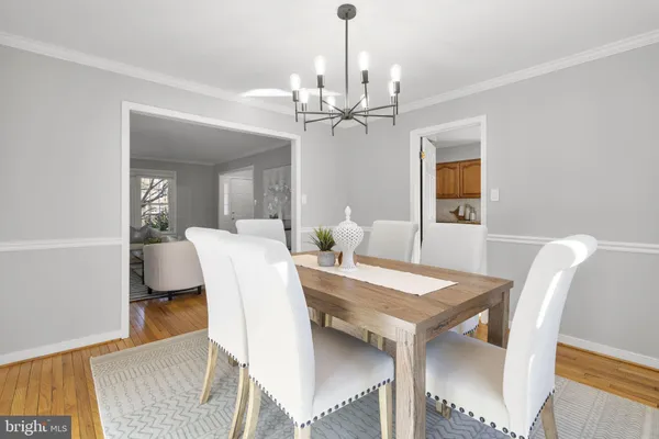 a view of a dining room with furniture and chandelier