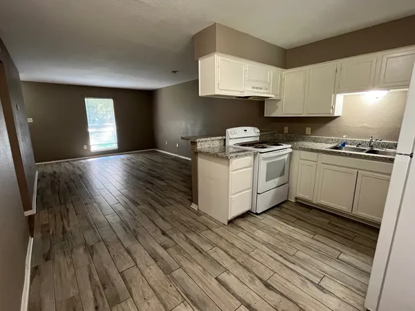 a kitchen with a stove top oven and cabinets
