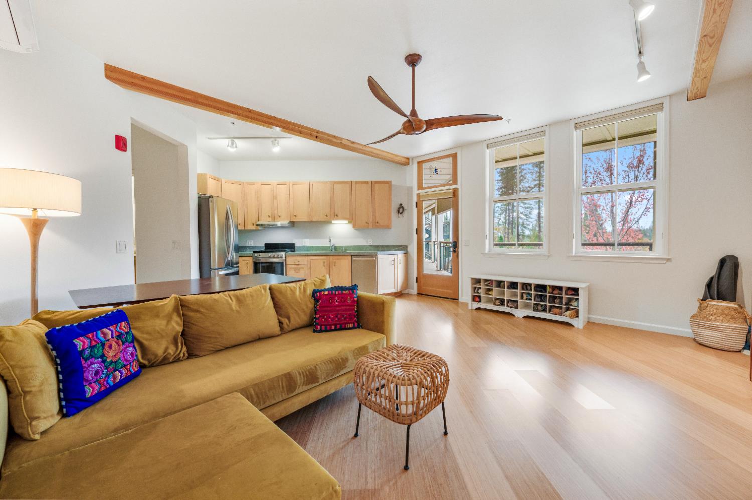 a living room with furniture and a wooden floor