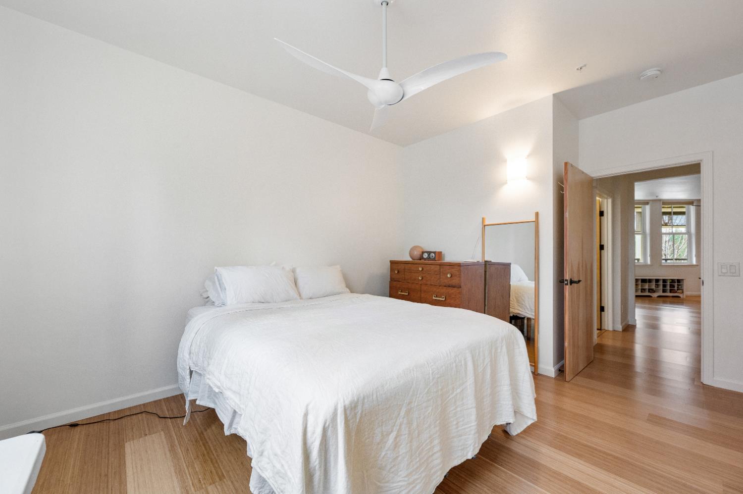 800 Freeman Lane, Unit 207 Grass Valley, CA 95949 - Photo 11 of 29 a bedroom with a bed and wooden floor