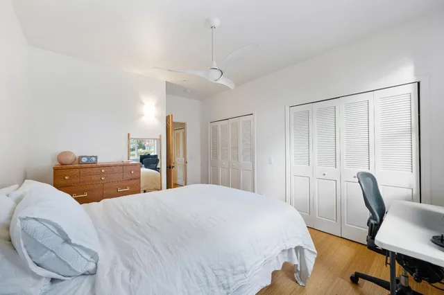 a bedroom with a large bed a desk and chair