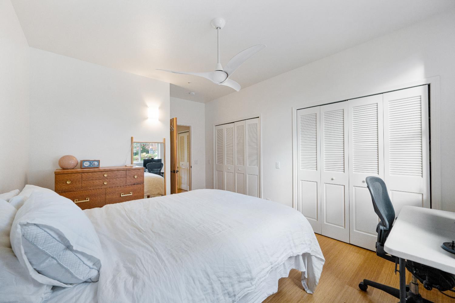 800 Freeman Lane, Unit 207 Grass Valley, CA 95949 - Photo 12 of 29 a bedroom with a large bed a desk and chair