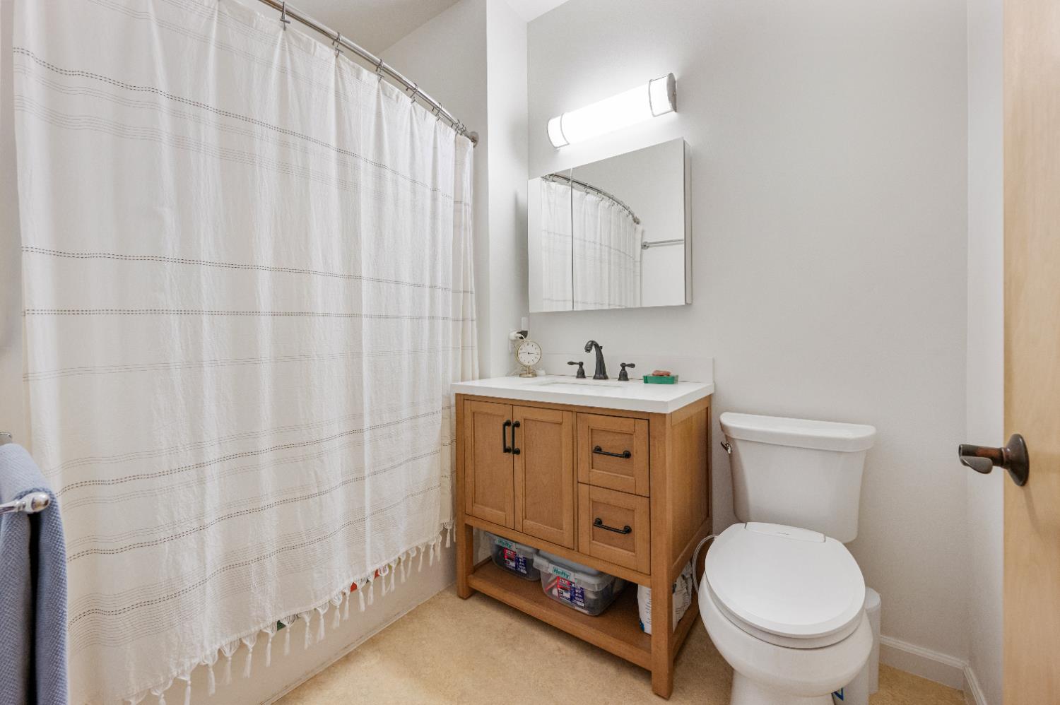 800 Freeman Lane, Unit 207 Grass Valley, CA 95949 - Photo 13 of 29 a bathroom with a toilet sink vanity and mirror