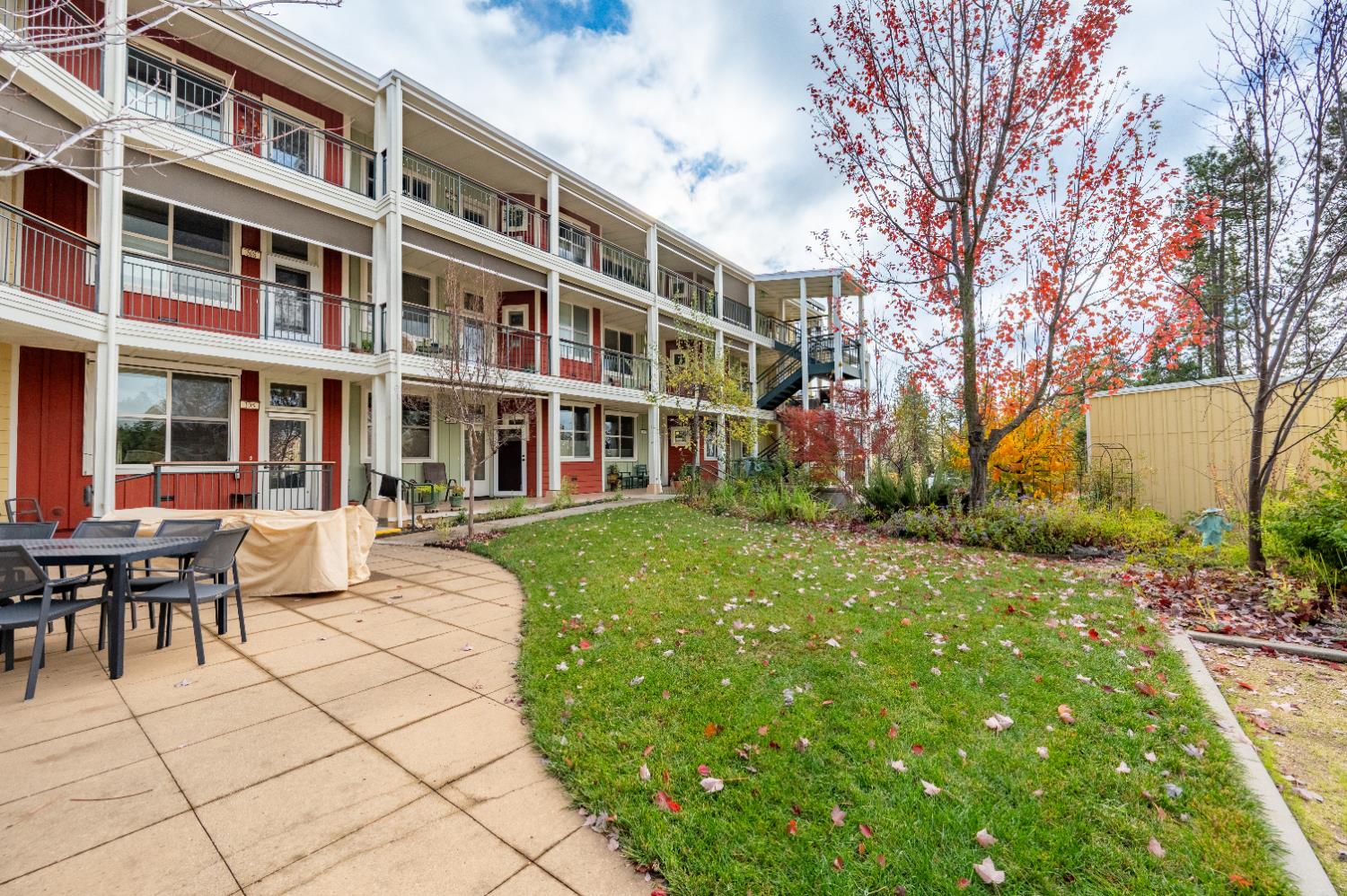 800 Freeman Lane, Unit 207 Grass Valley, CA 95949 - Photo 18 of 29 a front view of a building with a garden and trees