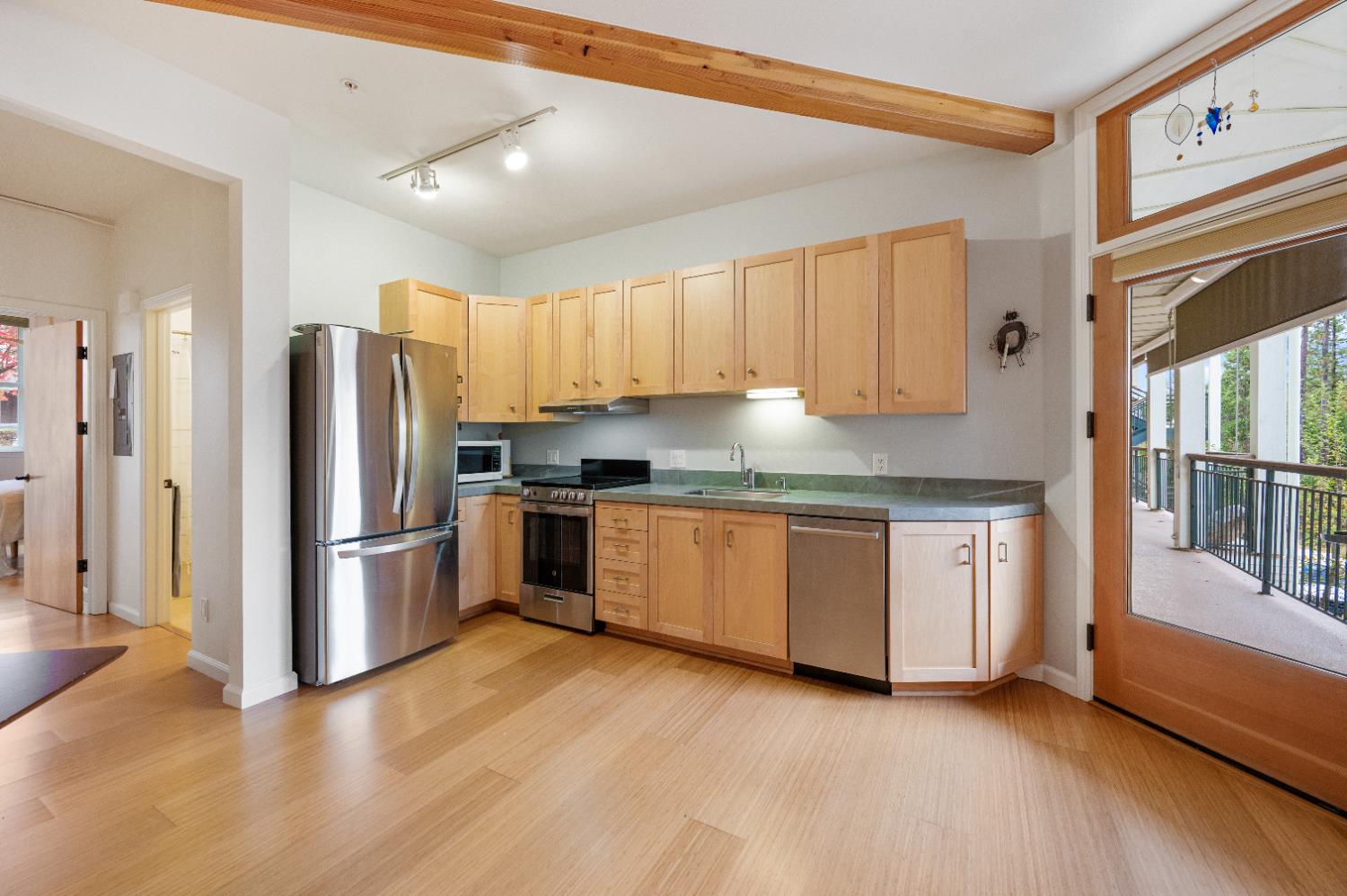 800 Freeman Lane, Unit 207 Grass Valley, CA 95949 - Photo 7 of 29 a kitchen with granite countertop a refrigerator and a stove top oven