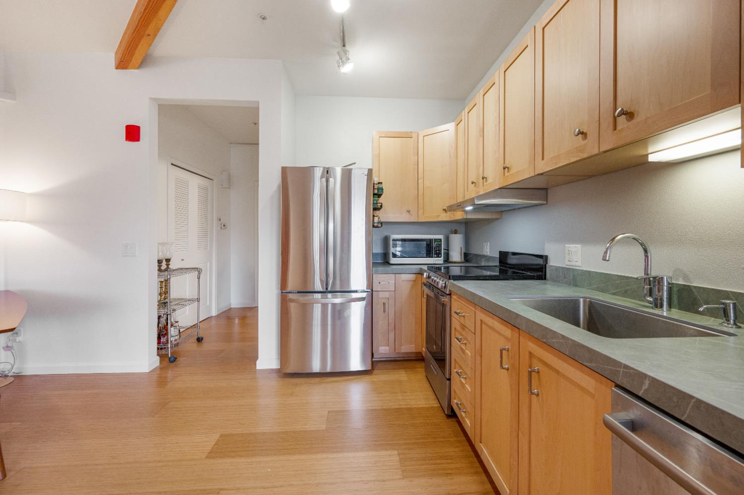 800 Freeman Lane, Unit 207 Grass Valley, CA 95949 - Photo 9 of 29 a kitchen with granite countertop a refrigerator and a sink