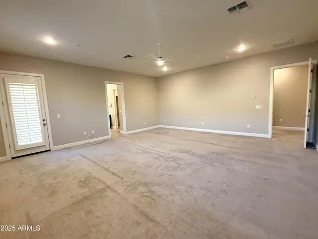 an empty room with windows and closet