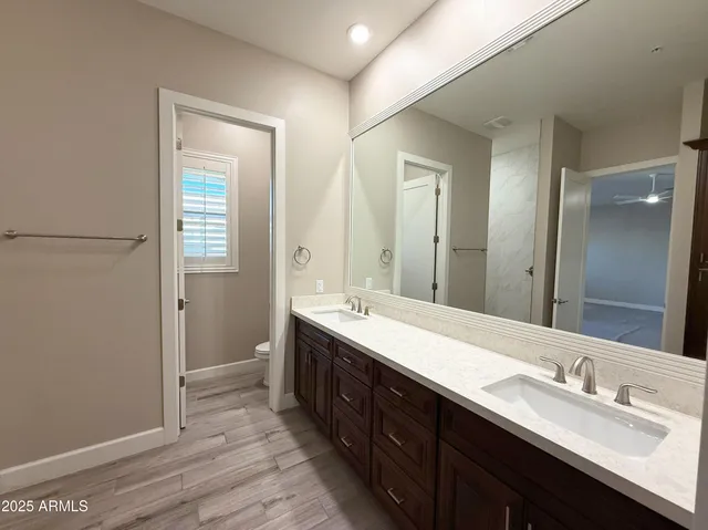 an empty room with a ceiling fan and window