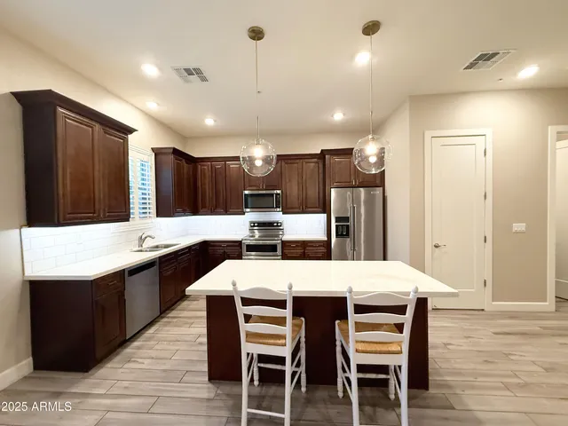 a large kitchen with a table and chairs