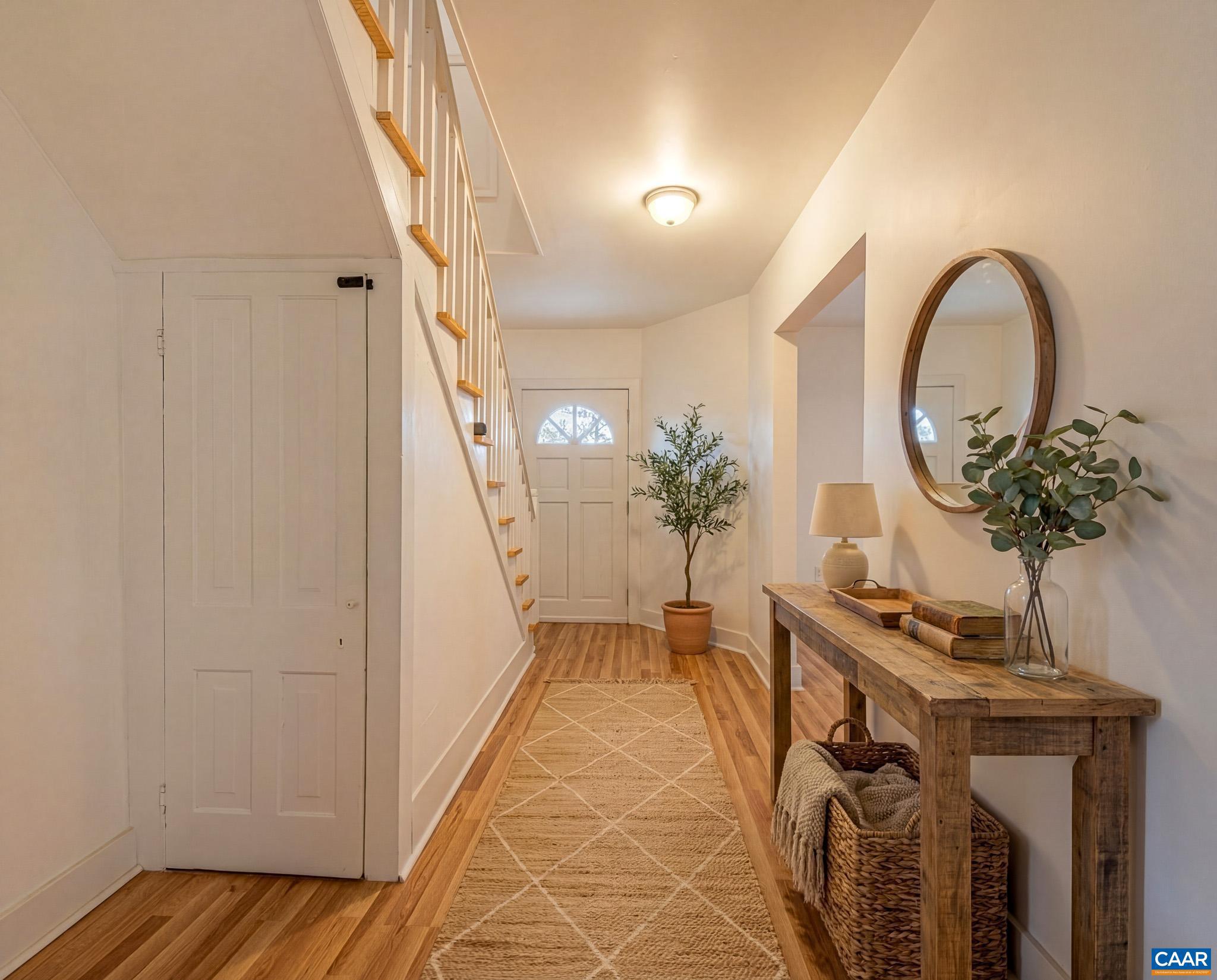 67 Lentz Lane Shipman, VA 22971 - Photo 4 of 31 a view of a hallway with wooden floor and a potted plant