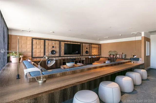 a view of a kitchen with kitchen island granite countertop a sink and a living room view