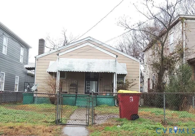 a front view of house with a garden