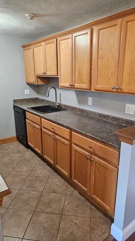 a kitchen with granite countertop a sink and a window