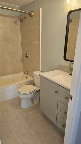 a bathroom with a toilet sink and shower