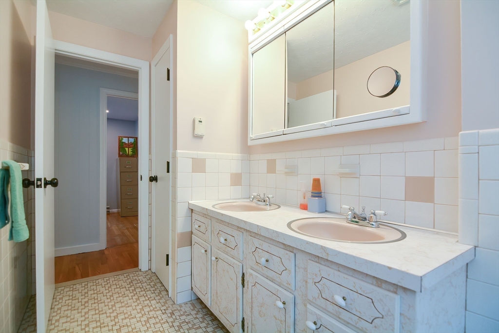 123 Capper Drive Canton, MA 02021 - Photo 12 of 32 a bathroom with a sink and a mirror
