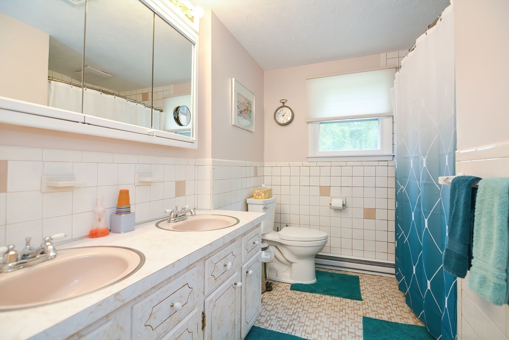 123 Capper Drive Canton, MA 02021 - Photo 13 of 32 a bathroom with a sink a toilet and a mirror