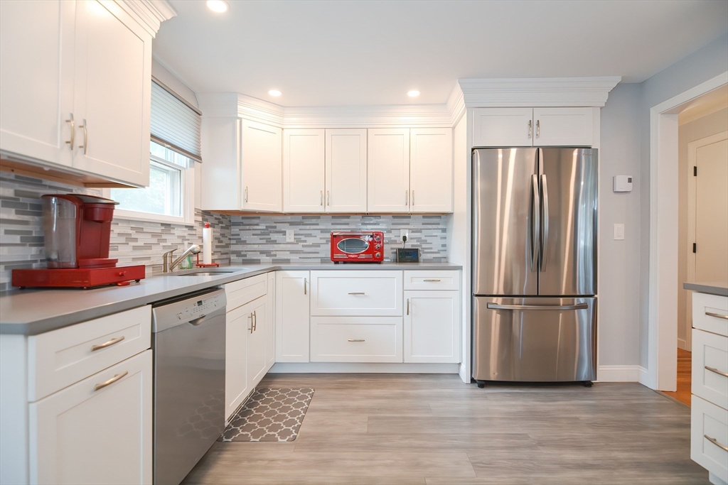 123 Capper Drive Canton, MA 02021 - Photo 3 of 32 a kitchen with stainless steel appliances a refrigerator sink and cabinets