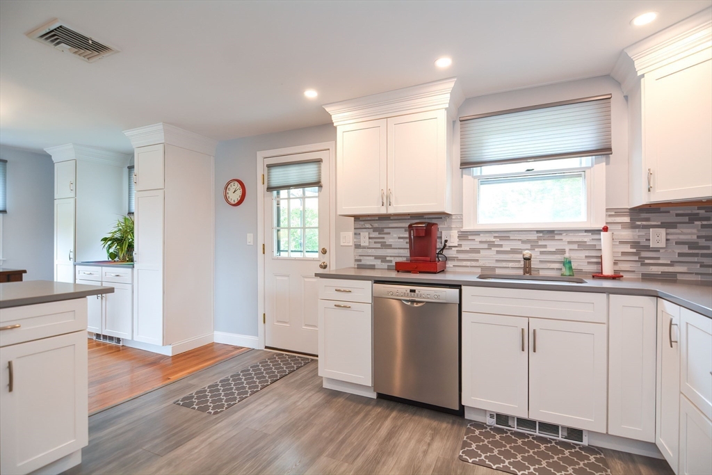123 Capper Drive Canton, MA 02021 - Photo 5 of 32 a kitchen with stainless steel appliances a stove a sink cabinets and a window
