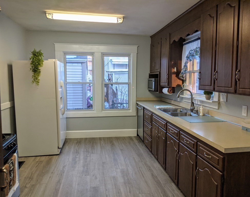 37 Montcalm Street Springfield, MA 01151 - Photo 8 of 33 a large kitchen with a sink a window and stainless steel appliances