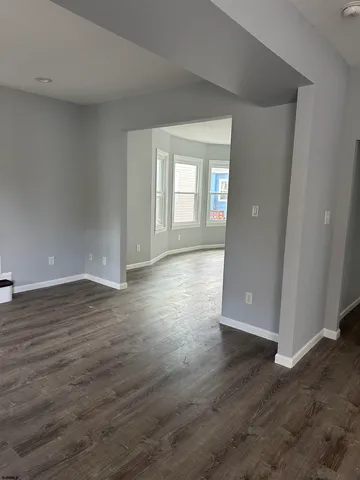 a view of wooden floor and windows in an empty room