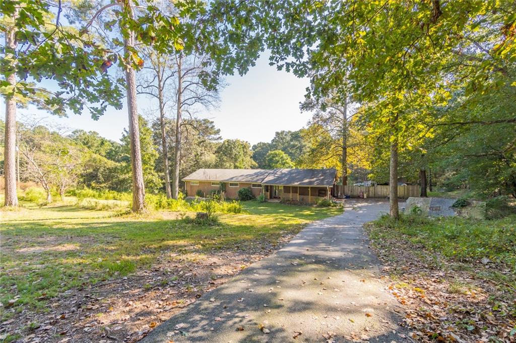 8630 Smith James Road Snellville, GA 30039 - Photo 1 of 1 a view of a house with a yard and sitting area