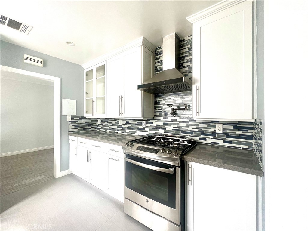 3155 Brookhill Street La Crescenta, CA 91214 - Photo 12 of 28 a kitchen with stainless steel appliances granite countertop a stove and a refrigerator