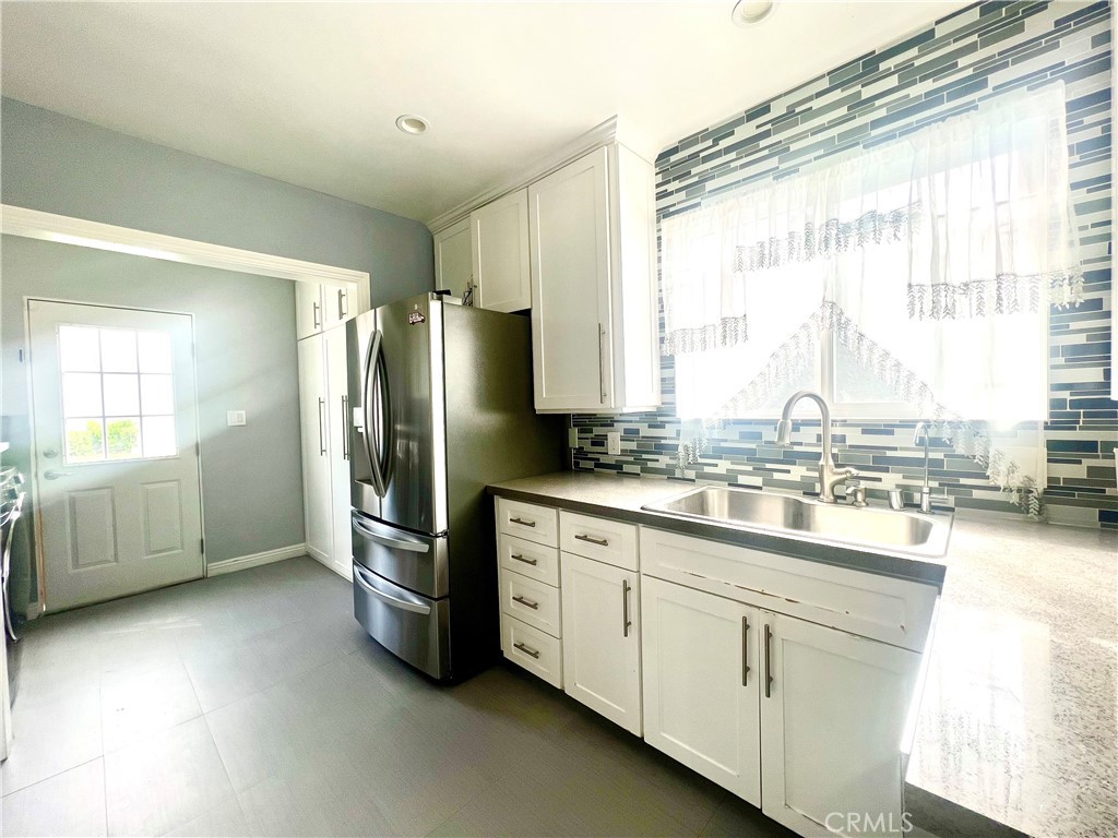 3155 Brookhill Street La Crescenta, CA 91214 - Photo 16 of 28 a kitchen with stainless steel appliances a sink cabinets and a large window